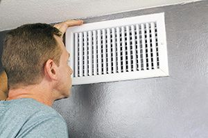 Person looking inside of a vent 