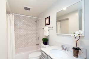 Bathroom with white tile and decor