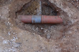 A sewer line revealed in the dirt 